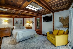 Charming loft bedroom with a queen bed and a skylight for starlit nights.