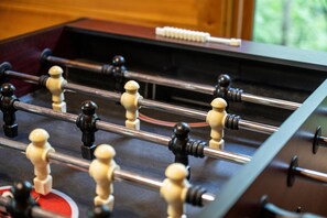 Challenge your family and friends to a lively game of foosball in a cozy, wood-accented space that’s perfect for friendly competition.