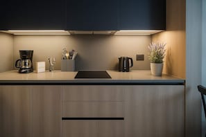 Modern kitchen with sleek cabinetry, perfect for preparing meals during your stay. Enjoy the comforts of home!