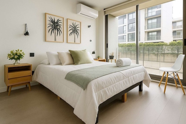 Relax in this cozy bedroom featuring modern decor and a stunning view, perfect for a peaceful getaway.