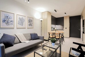 Modern living space with sleek kitchen and stylish decor, perfect for relaxing or entertaining in comfort.