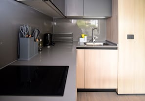 Experience a sleek, modern kitchen equipped with everything you need for a comfortable stay.