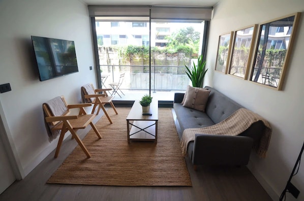 Bright and airy living room with modern decor, perfect for relaxing after a day of exploring. Enjoy the natural light and cozy atmosphere!