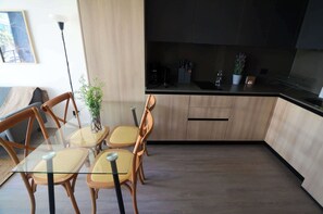 Enjoy a modern kitchen with a stylish dining area, perfect for meals and gatherings during your stay.