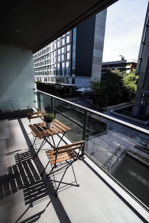 Enjoy a cozy outdoor space with a charming table and chairs, perfect for morning coffee or evening relaxation.