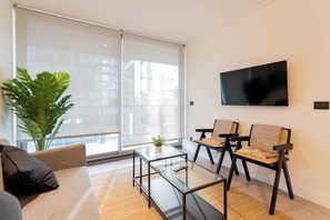 Bright and modern living room with stylish furnishings and a cozy atmosphere, perfect for relaxation after a day of exploring.