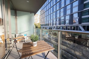 Enjoy a cozy balcony retreat with a modern view, perfect for sipping morning coffee or unwinding in the evening.