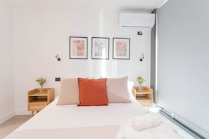Experience comfort in this beautifully decorated bedroom, featuring cozy bedding and charming artwork for a relaxing retreat.