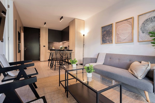 Experience modern comfort in this stylish living space, featuring an open layout, chic decor, and a cozy atmosphere perfect for relaxation.