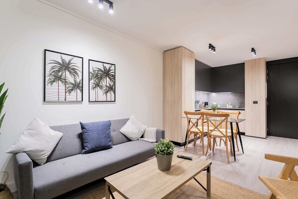 Modern living space with cozy seating, stylish dining area, and a sleek kitchen—perfect for a relaxing stay.