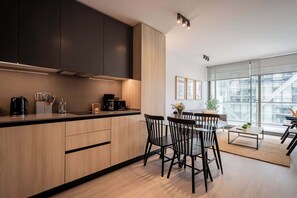 Experience modern living in this stylish kitchen, featuring sleek cabinetry and abundant natural light, perfect for your culinary adventures.