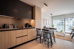 Experience modern living in this stylish kitchen, featuring sleek cabinetry and abundant natural light, perfect for your culinary adventures.