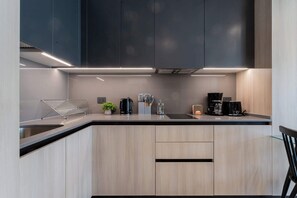 Experience culinary bliss in this modern kitchen, featuring sleek cabinetry and high-end appliances for your cooking adventures.