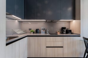 Experience culinary bliss in this modern kitchen, featuring sleek cabinetry and high-end appliances for your cooking adventures.