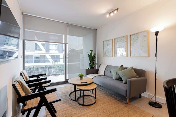 Experience modern comfort in this stylish living room, featuring large windows and cozy seating—perfect for relaxation after a day of adventure!