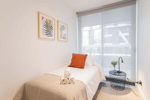 Cozy and modern bedroom with a touch of elegance, perfect for a restful stay. Enjoy the serene atmosphere and thoughtful details.