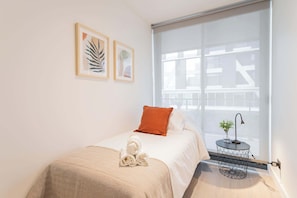 Cozy and modern bedroom with a touch of elegance, perfect for a restful stay. Enjoy the serene atmosphere and thoughtful details.