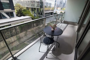 Enjoy a cozy balcony retreat with city views, perfect for morning coffee or evening relaxation.