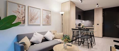 Cozy living space with modern kitchen and dining area, perfect for relaxation and entertaining in style.