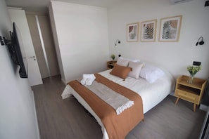 Experience comfort in this stylish bedroom featuring a cozy queen bed, modern decor, and a serene atmosphere for your perfect getaway.