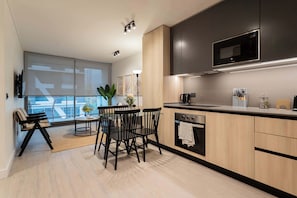 Experience modern elegance in this stylish kitchen and dining area, perfect for cozy meals and gatherings.