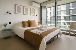 Relax in this cozy bedroom featuring stylish decor, plush bedding, and a serene atmosphere for your perfect getaway.