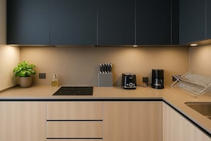 Modern kitchen equipped with sleek appliances and utensils, perfect for preparing meals during your stay.