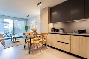 Experience modern living in this stylish kitchen and dining area, filled with natural light and contemporary decor for a cozy getaway.
