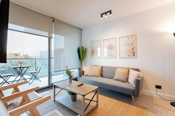 Bright and modern living room with a cozy balcony, perfect for relaxing and enjoying the view.