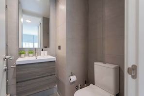Experience a modern bathroom retreat with sleek design and thoughtful touches for your comfort.