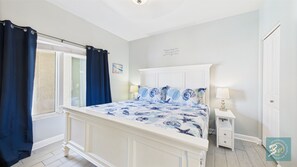 Master bedroom with king bed TV and ensuite bathroom