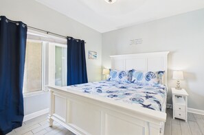 Master bedroom with king bed TV and ensuite bathroom