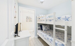 Bunk room with twin-over-twin beds in hallway and ensuite bathroom