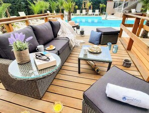Outdoor seating by the pool – Comfortable lounge area near the pool, ideal for relaxation.

