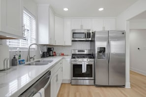 Everything you need for culinary perfection ✨ Our elegant kitchen features a refrigerator, stove, oven, and microwave, making cooking a breeze. 🍴