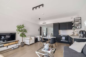 This rental property features a modern kitchen, dining area, and living room.
