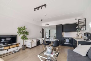 This rental property features a modern kitchen, dining area, and living room.