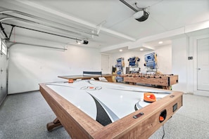 Garage/game room with ping pong, foosball, and air hockey table