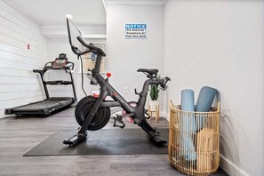 Fitness room with treadmill and peloton bike