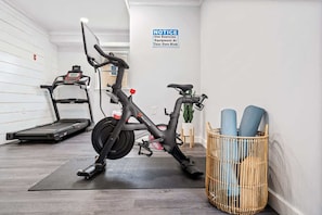 Fitness room with treadmill and peloton bike