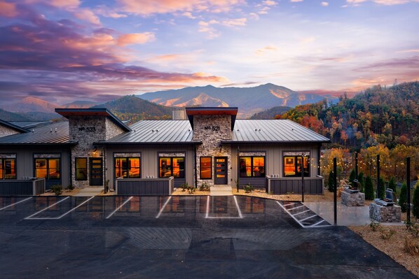 The exterior of the cabin  with a vivid mountain view.