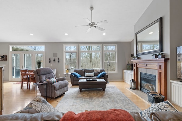 Open spacious living area with 80" Smart TV and plenty of seating.