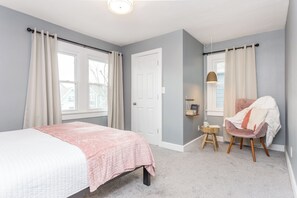 Primary bedroom #2 offers a comfortable queen bed with reading nook and spacious closet.