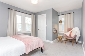 Primary bedroom #2 offers a comfortable queen bed with reading nook and spacious closet.