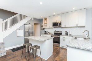 Whether enjoying take out or cooking a meal at home, the spacious kitchen is stocked with all the essentials you'll need during your stay.
