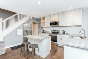 Whether enjoying take out or cooking a meal at home, the spacious kitchen is stocked with all the essentials you'll need during your stay.