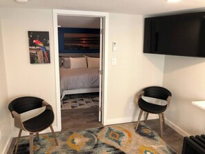 50" Smart TV in living room, door to master bedroom.