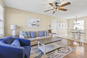 Relax in the inviting living room at Portside Haven, featuring soothing blue accents.