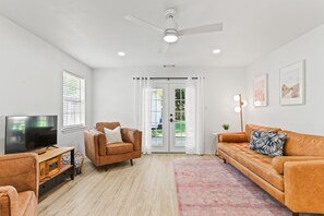 Kick back and relax in the spacious living area, where French doors open to the backyard and let the island breeze drift right in.