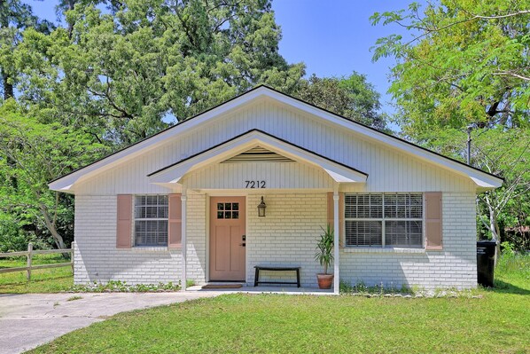 The charming painted brick exterior adds the perfect touch of character—welcoming you home with a little Southern flair.